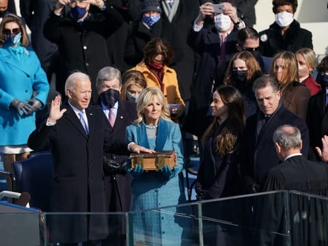 Joe Biden is sworn in as the 46th President of the United States at the Capitol in Washington on Wednesday, Jan. 20, 2021, as his wife Jill Biden holds a bible.