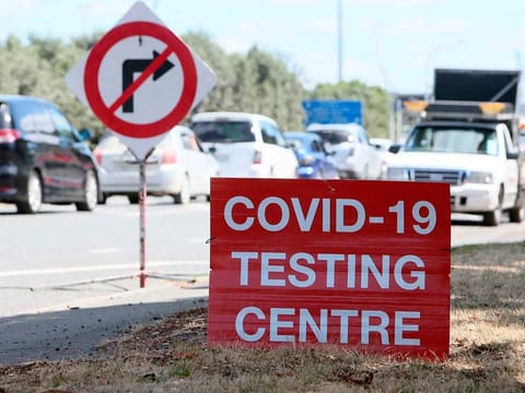 Signs direct drivers waiting for a COVID-19 testing at a pop-up testing centre at Marsden Point, New Zealand, on Monday, Jan. 25, 2021. Health officials in New Zealand say genome tests indicate the country's most recent COVID-19 patient contracted the virus from another returning traveler just before leaving quarantine. 