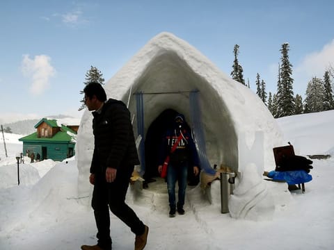 Tourists come out from the first Igloo Cafe at Gulmarg near Srinagar.