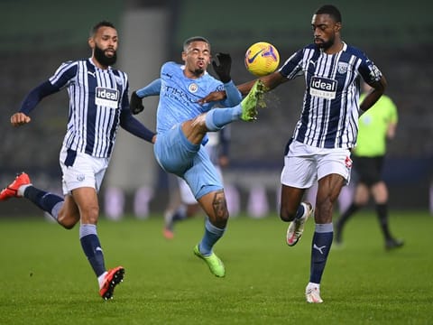 Manchester City's Gabriel Jesus (centre) is challenged by West Bromwich Albion's Semi Ajayi and Kyle Bartley during their Premier League match, which City won 5-0.  