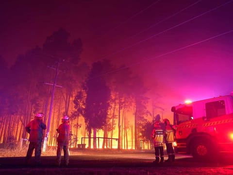 Firefighters attend a fire at Wooroloo, near Perth, Australia, Monday, Feb. 1, 2021. An out-of-control wildfire burning northeast of the Australian west coast city of Perth has destroyed an estimated 30 homes and was threatening more Tuesday, with many locals across the region told it is too late to leave. 