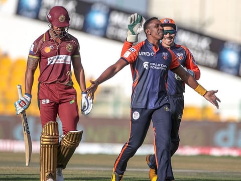 Dwayne Bravo (centre), the Delhi Bulls captain, exults after claiming the wicket of prolific Nicholas Pooran of Northern Warriors.