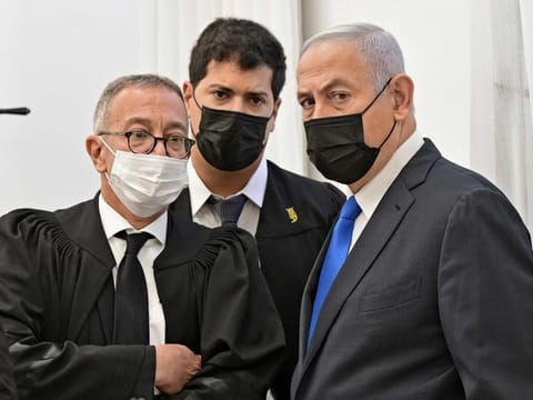 Israeli Prime Minister Benjamin Netanyahu looks on during a hearing in his corruption trial at the Jerusalem district court, on February 8, 2021. 