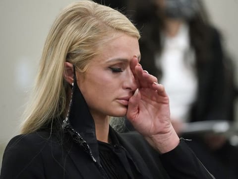 Paris Hilton wipes her eyes after speaking at a committee hearing at the Utah State Capitol, Monday, Feb. 8, 2021, in Salt Lake City. Hilton has been speaking out about abuse she says she suffered at a boarding school in Utah in the 1990s and she testified in front of state lawmakers weighing new regulations for the industry. 