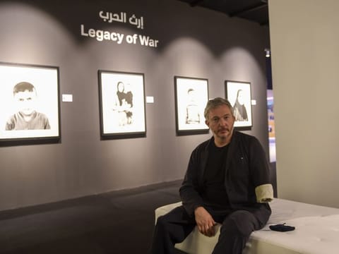 Giles Duley, documentary photographer and writer, with his work at Xposure 2021, at Sharjah Expo Centre, on Wednesday. 