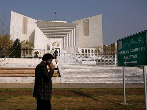 A man walks past the Supreme Court building in Islamabad, Pakistan, Wednesday, Feb. 10, 2021. In a landmark ruling, Pakistan's top court on Wednesday commuted the death sentences of two mentally ill prisoners who have spent decades on death row.