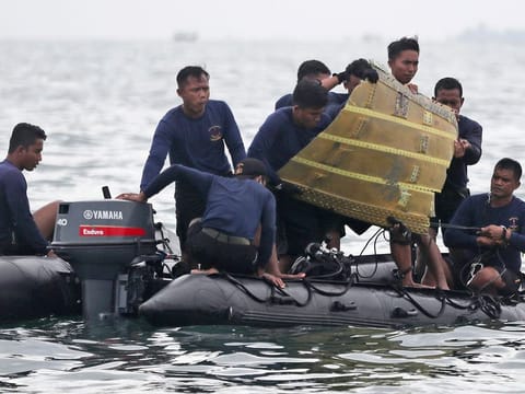 File photo: Indonesian Navy divers pull out a part of an airplane out of the water during a search operation for a Sriwijaya Air Boeing 737-500 passenger jet that crashed into the sea near Jakarta. 