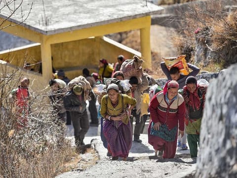 Flood-affected villagers of Bhalla gaon after receiving relief material from authorities, in Chamoli district of Uttarakhand, Friday, Feb. 12, 2021. 