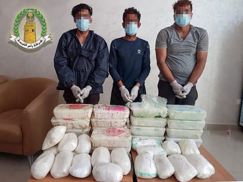 A group of drug peddlers with their stash after being arrested by police.