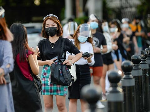 People wearing face masks and face shields as protection from the coronavirus disease (COVID-19) queue outside a newly reopened historical site, in Manila, Philippines, February 18, 2021. 