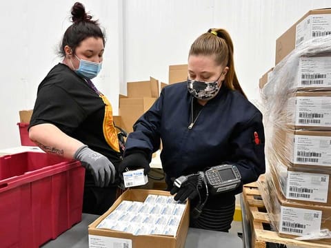Employees with the McKesson Corporation scan a box of the Johnson &  Johnson COVID-19 vaccine while filling an order at their shipping facility in Shepherdsville, Ky., Monday, March 1, 2021.