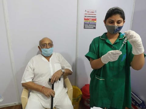 An elderly man waits to be administered Covishield COVID-19 vaccine in Mumbai, India, Monday, March 8, 2021.