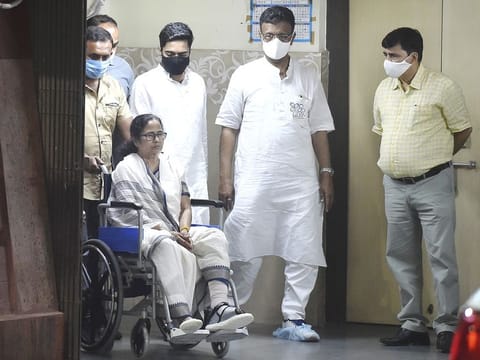 West Bengal Chief Minister Mamata Banerjee, sitting in a wheel-chair, seen while being discharged from SSKM Hospital in Kolkata, on Friday. 