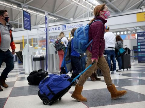 Officials say people who haven't gotten the shots should delay travel.