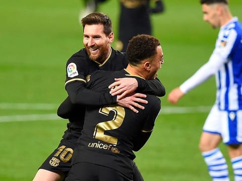 Lionel Messi celebrates with Sergino Dest after scoring for Barcelona.