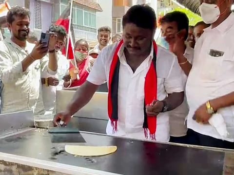 DMK's Virugambakkam candidate Prabhakar Raja makes a dosa and while campaigning for the assembly elections, in Chennai on Tuesday, March 23, 2021. 