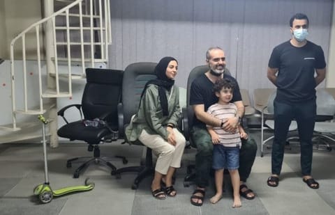 The boy with his parents after Dubai Police found him.