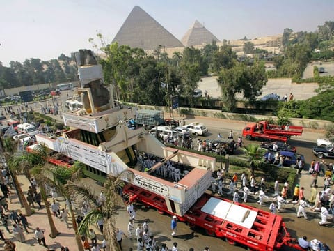 In this file photo taken on August 25, 2006, the massive statue of Ramses II, a 100-tonne, 11-meter-high pink granite colossus, is paraded on the street in Giza as it ends its journey from the polluted Egyptian capital city Cairo to a spot near the Pyramids and closer to its original site. 
