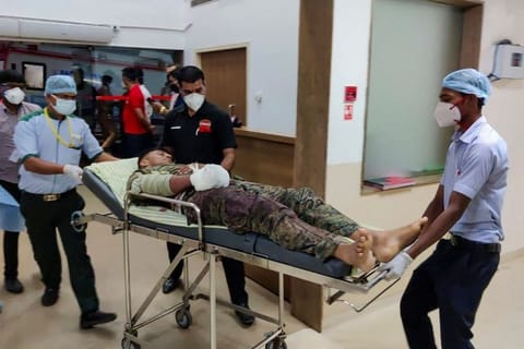 Medical workers bring an injured soldier on a stretcher for treatment in a hospital following a gun battle with Maoist rebels.