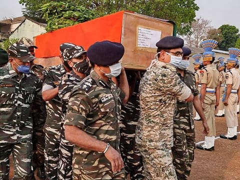 CRPF personnel carry the coffin of a paramilitary soldier who lost his life in an encounter with Maoists, in Bijapur district of Chhattisgarh, Sunday, April 4, 2021. 