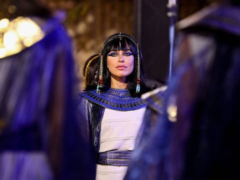 Performers dressed in ancient Egyptian costumes wait at the start of the parade of 22 ancient Egyptian royal mummies departing from the Egyptian Museum in Cairo's Tahrir Square on April 3, 2021.
