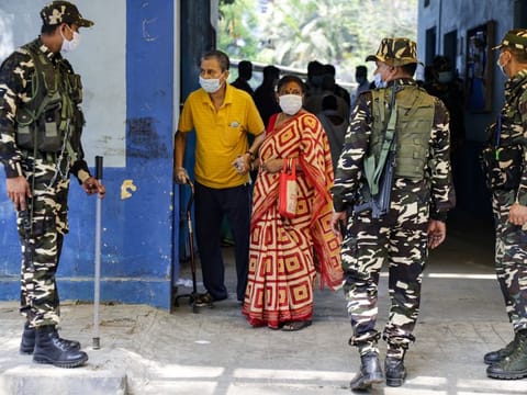 Elderly voters come out after casting their votes as paramilitary soldiers stand guard at a polling station during fourth phase of assembly elections near Kolkata in West Bengal on Saturday.