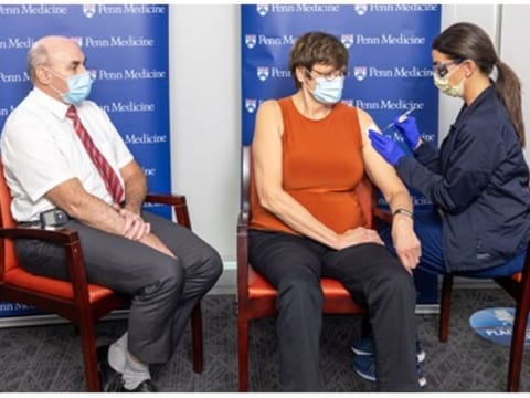 Dr Drew Weissman (left) and Dr Katalin Kariko (centre) take the mRNA shot which they invented. They collaborated for years to develop the mRNA technology that helped lead the world in the fight against the coronavirus pandemic.