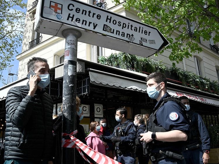 French police cordon off the area near the Henry Dunant private hospital where one person was shot dead and one injured in a shooting outside the instituion owned by the Red Cross in Paris' upmarket 16th district on April 12, 2021. 