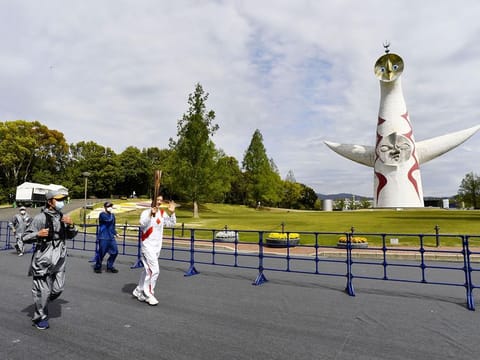 Former Japanese backstroke swimmer Aya Terakawa, a Tokyo 2020 Olympic torch relay runner, runs at the Expo '70 Commemorative Park without spectators instead of on public roads due to the coronavirus disease (COVID-19) outbreak in Osaka, western Japan April 13, 2021,