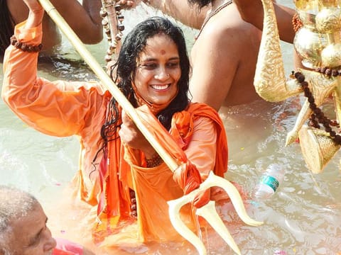A Sadhvi of Niranjani Akhada takes a holy dip at Har ki Pauri during Kumbh, in Haridwar on Wednesday.  