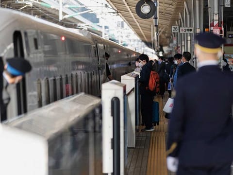 Passengers wearing face masks to help curb the spread of the coronavirus get on a bullet train at the Shin Osaka Station in Osaka, western Japan, Tuesday, April 20, 2021. 