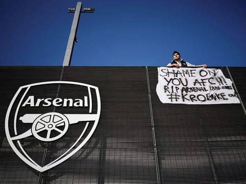 An Arsenal fan stands with his anti-European Super League banner outside the Emirates Stadium on April 19, 2021.