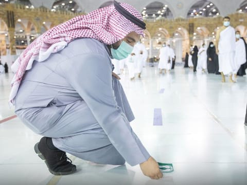 Signs are put on the floor of the courtyard in the Grand Mosque to mark safe distancing. 