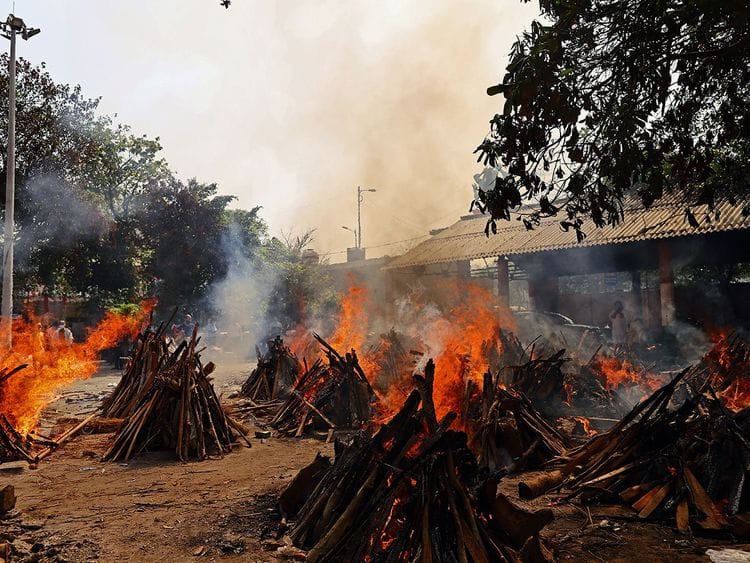 Funeral pyres of COVID-19 fatalities burn at a crematorium in New Delhi