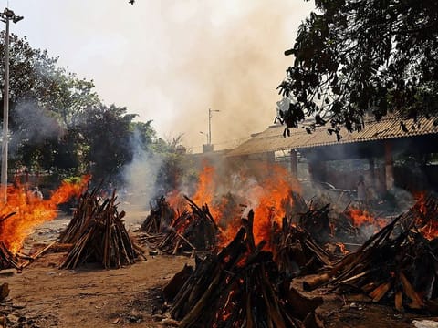 Funeral pyres of COVID-19 fatalities burn at a crematorium in New Delhi, on Friday, April 23, 2021. 