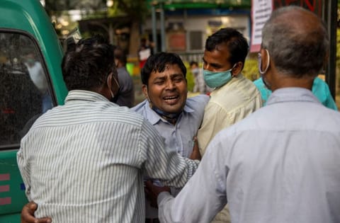 Family members mourn after a man is declared dead outside the coronavirus disease casualty ward, at Guru Teg Bahadur hospital, amidst the spread of the disease in New Delhi, India, April 23, 2021. 