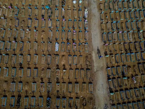 Aerial view of a gravedigger walking among COVID-19 victims' graves at the Nossa Senhora Aparecida cemetery in Manaus, Amazonas state, Brazil, on April 29, 2021. Brazil surpassed Thursday 400,000 deaths due to COVID-19, and is second in number only to the US. 