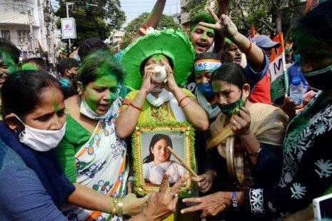 TMC supporters celebrate the party's victory during the election result day for West Bengal Assembly election, in Kolkata on Sunday. 
