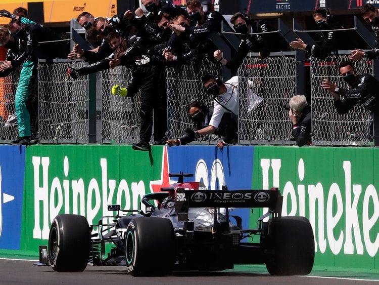 Lewis Hamilton is greeted by the Mercedes team after his win in Portugal