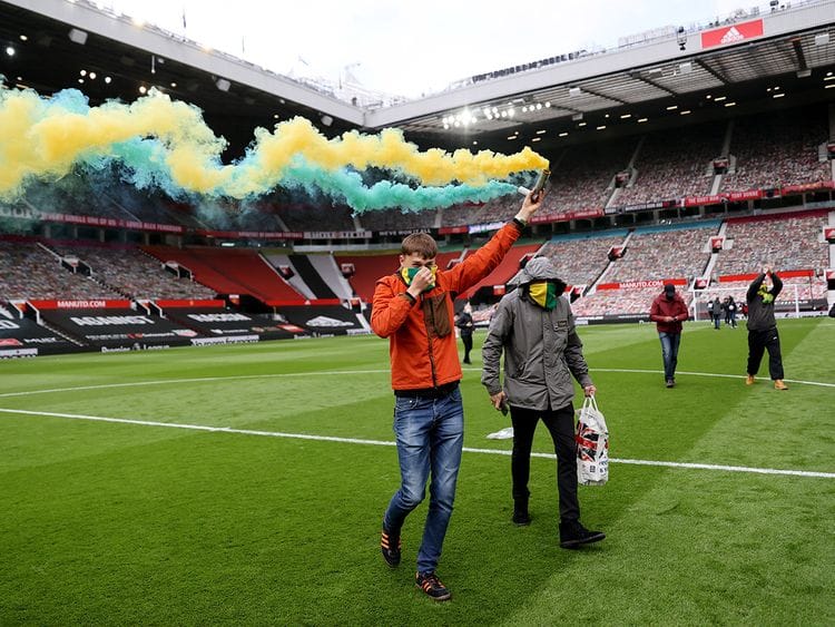 Manchester United fans invade the pitch in protest against club owners.