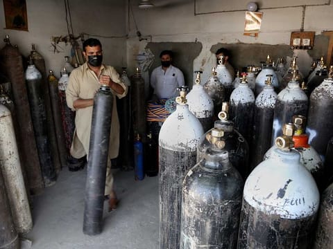 A vendor arranges oxygen cylinders which will be supplied to COVID-19 patients, in Peshawar, Pakistan. The country is going into a 10-day lockdown from tomorrow in a bid to curb the spread of COVID-19.