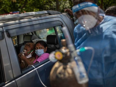 A patient receives oxygen inside a car provided by a Gurdwara, a Sikh place of worship, in New Delhi, India. 