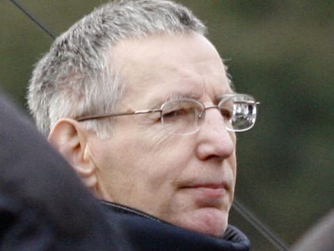 In this file photo taken on March 15, 2006 French self-confessed serial killer Michel Fourniret, is seen 15 March 2006 in Reze, western France, during the reenactement of the rape and murder of Natacha Danais, 13, who was kidnapped 21 November 1990 and found dead three days later on a beach in Bretignolles-sur-Mer. 