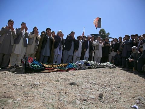 Afghans pray during the funeral of victims of deadly bombings on Saturday near a school, at a cemetery west of Kabul, Afghanistan, Sunday, May 9, 2021. 