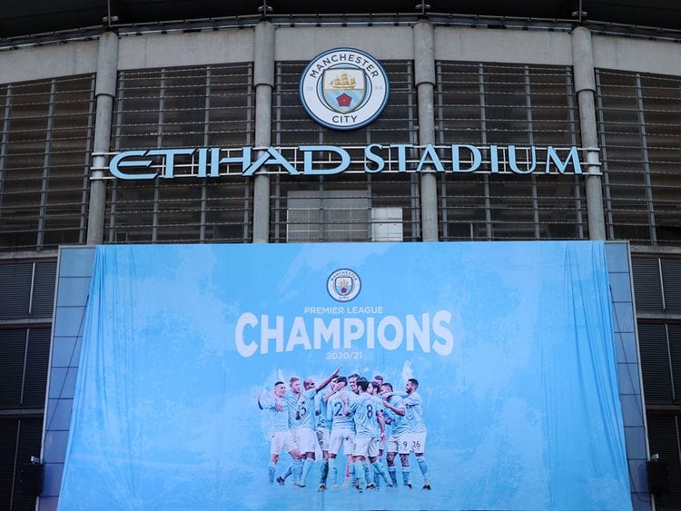 A flag is unfurled at Etihad Stadium proclaiming Manchester City as champions
