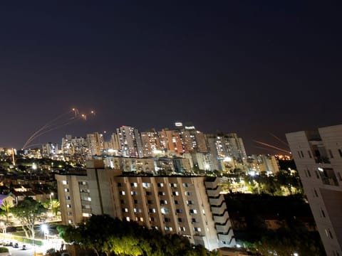 Streaks of light are seen in this file 2021 picture as Israel's Iron Dome anti-missile system intercepts rockets launched from the Gaza Strip.