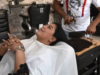 In photos: With cleavers and blowtorches, Pakistan barber offers hair-raising cuts