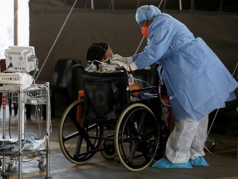File photo: A healthcare worker tends to a patient at a temporary ward set up during the COVID-19 outbreak, at Steve Biko Academic Hospital in Pretoria, South Africa. 