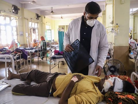A doctor assists a COVID-19 coronavirus patient with Black Fungus, a deadly and rare fungal infection, as he receives treatments at the NSCB hospital in Jabalpur, on May 20, 2021.