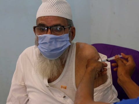 A man receives the second shot of the AstraZeneca COVID-19 vaccine from a health worker at a vaccination centre in Lahore, Pakistan, Sunday, May 16, 2021. 